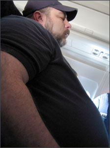 picture shows a fat, wheezing man in an aisle seat
