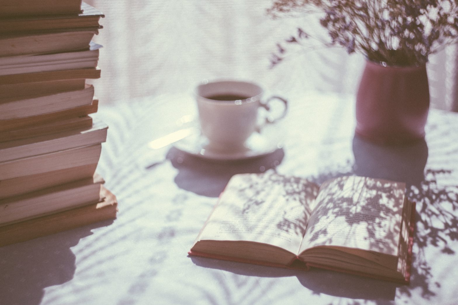 Photo of a reader's books on a table, by freestocks on Unsplash